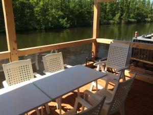 a table and chairs on the deck of a boat at Bootshaus Mirow in Mirow