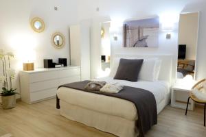 a bedroom with a large white bed with two towels on it at Arles Getaway - La Suite Arlésienne in Arles