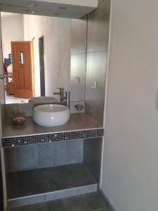 a bathroom with a sink and a mirror at La Alquimia Casas de Campo in La Granja