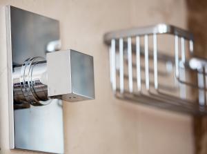 a close up of a soap dispenser on a wall at Capri Wine Hotel in Capri