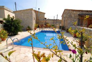 a swimming pool in front of a house at Anesi House in Skarinou
