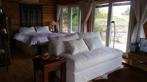a living room with a couch and a bed at El Ahora in El Eden +18 photos