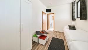 a white bedroom with a bed and a table at Apartment Sandro in Vilanija +38 photos