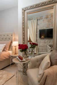 a living room with a couch and a mirror at Jupiter Lux Rooms in Split