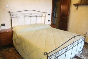 a bedroom with a bed with a white bedspread at Bed & Breakfast Triora Medievale in Triora