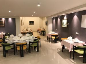 a dining room with tables and chairs with white tablecloths at Hotel Sunce in Neum