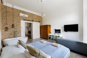 a living room with a couch and a tv at Buda Castle Apartment in Budapest