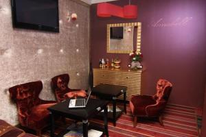 a living room with a laptop on a table and chairs at Annabelle отель in Odesa