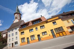 a yellow building with a clock tower on top of it at B&B Appartements Bischof & Bürk GbR in Tuttlingen