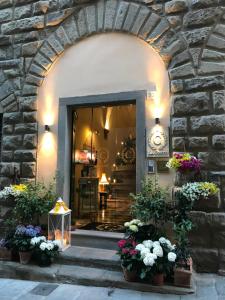 an entrance to a building with flowers in pots at La Corte Di Ambra in Cortona