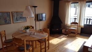 a dining room with a table and a wood stove at Sälens Bed & Breakfast in Sälen