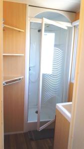 a glass shower in a kitchen with a sink at La Canardiere in Casta