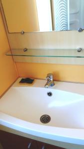 a bathroom with a sink and a mirror at La Canardiere in Casta
