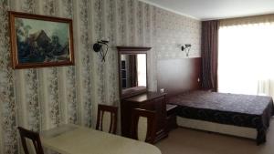 a bedroom with a bed and a table and a mirror at Private Studio 1st line in Pomorie +52 photos