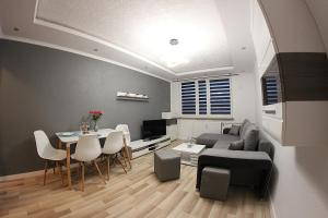 a living room with a couch and a table at Family Apartments in Racibórz