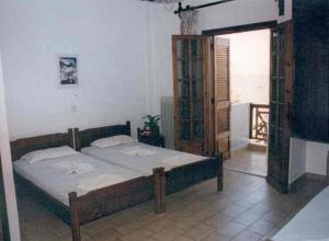 a bedroom with a large bed and a window at Nea Elena Apartments in Chania