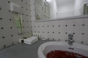 a white bathroom with a sink and a mirror at Scuba Inn in Omadhoo +77 photos