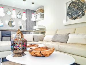 a living room with a white couch and a table at Townhouse Costa Adeje in Adeje