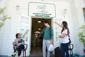 a group of people standing outside of a building at The Great House Inn in Belize City