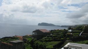 a view of a large body of water with a house at Ilhéus à vista in Feteira
