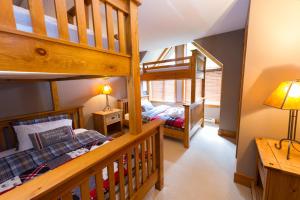 a bedroom with two bunk beds and a staircase at Snowberry Villas in Whistler