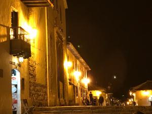 a city street at night with lights on buildings at Casas del Viento in Villa de Leyva