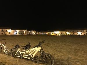 two bikes parked on the beach at night at Casas del Viento in Villa de Leyva +12 photos