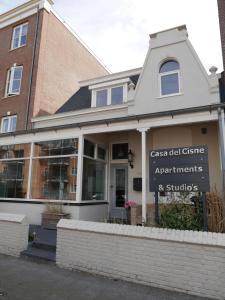 a building with a sign in front of it at Casa Del Cisne in Zandvoort