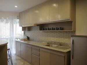 a kitchen with a sink and a counter top at Bohol Dreamcatcher Resort in Panglao Island