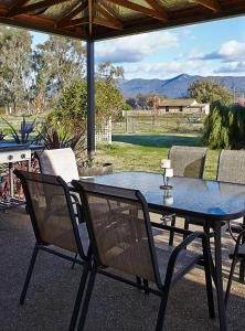 a table and chairs sitting on a patio at La Casa in Myrtleford
