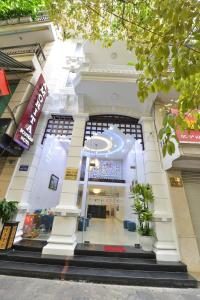 a building with a clock on the front of it at Amorita Boutique Hotel Hanoi in Hanoi
