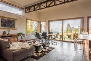a living room with a couch and a table at Hotel Patagonia House in Coihaique