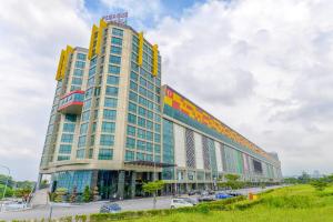 a large building with yellow and blue windows at Pegasus Hotel Shah Alam in Shah Alam