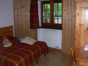 Postel nebo postele na pokoji v ubytování Agriturismo Lo Ratelé