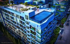 an overhead view of a building with a swimming pool at Acqua apartments in Jomtien Beach