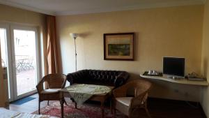 a living room with a couch and a table at Bed and Breakfast Dannevirke in Owschlag