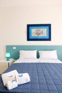 a bedroom with a bed with towels on it at La Dimora Salento in Carovigno +42 photos
