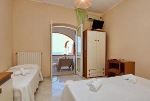 Postel nebo postele na pokoji v ubytování Hotel Costa d'Oro