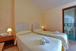 Postel nebo postele na pokoji v ubytování Hotel Costa d'Oro