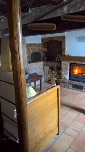 a room with a fireplace and a table in front at Chambre d Hote 1873 in Frasne