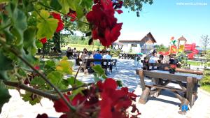 a group of people sitting on a park bench at Lovac Motel & Restaurant in Donji Žabar