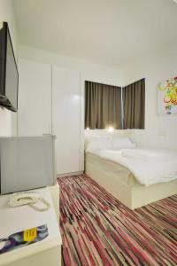 Postel nebo postele na pokoji v ubytování Pegasus Hotel Shah Alam