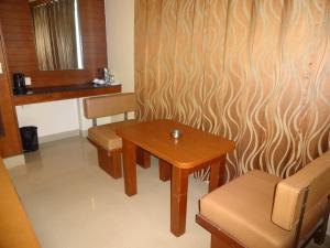 a room with a wooden table and two chairs at Sheetal Residency in Bangalore