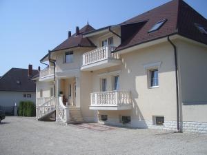 a large white building with balconies on it at Hegyi Villa in Hévíz