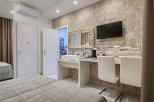 a bedroom with a desk and a bed and a television at Relais Vatican Secret in Rome