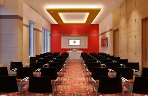 哥印拜陀ibis Coimbatore City Centre - An Accor Brand的大房间设有一排椅子和屏幕