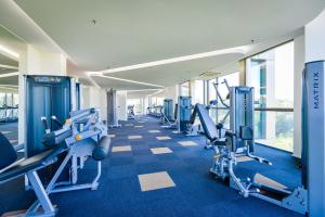 a gym with a row of treadmills and machines at Pegasus Hotel Shah Alam in Shah Alam