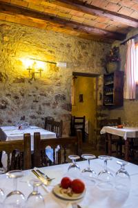 a dining room with two tables with wine glasses at Camping El Pasqualet in Caldes de Montbui