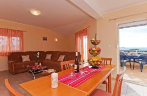 a living room with a table and a couch at Apartments Mara in Drage