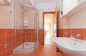 a bathroom with a sink and a shower at Apartments Mara in Drage +85 photos